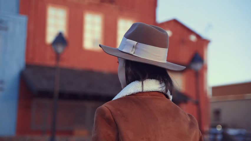 Attractive young girl in a hat outdoors