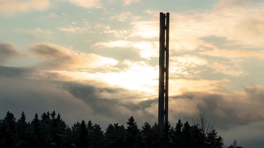 Timelapse o sun passing by a tower in Tampere, Finland. A lot of cloud movement darkening the sun in the end.