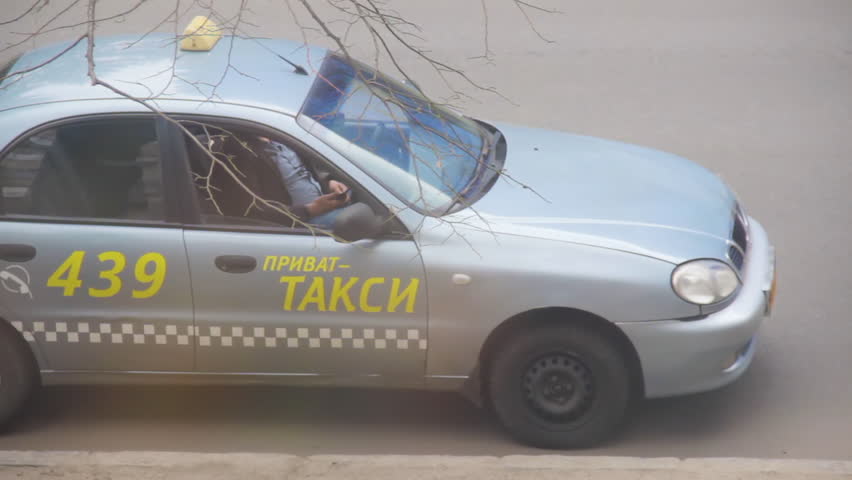DNIPRO, UKRAINE - March 27, 2019: Private taxi driver resting in his parked car with mobile phone in hand. Most orders are received from the dispatcher through applications or calls in smartphones | Shutterstock HD Video #1027247717