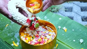Video slow-motion / Close-up Pour water on the hands of revered elders and gives blessing in Songkran day Thailand