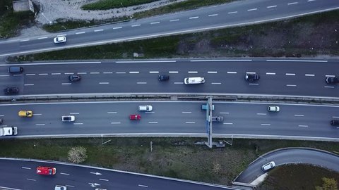 Car traffic on freeway drone aerial top down view footage, vehicles driving on highway road with ramp lanes, 4K video of transportation from above