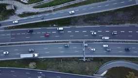 Highway traffic aerial top down view footage from drone with vehicles driving on freeway road with ramp lanes, 4K video of transportation from above