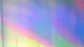 Holographic foil neon iridescent abstract motion background made of real material. Luminous surreal blurred moving gradient 80s, 90s concept. UHD 4K video.