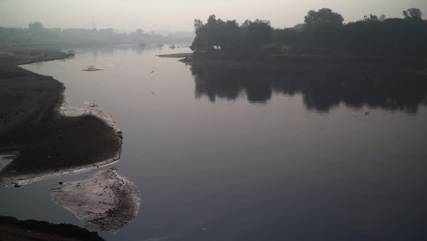 Water has dried out in rivers, Foggy weather view, camera panning up, Trees arround the river