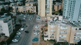 City drone flying over houses, monitoring order in yards, aerial view, israel
