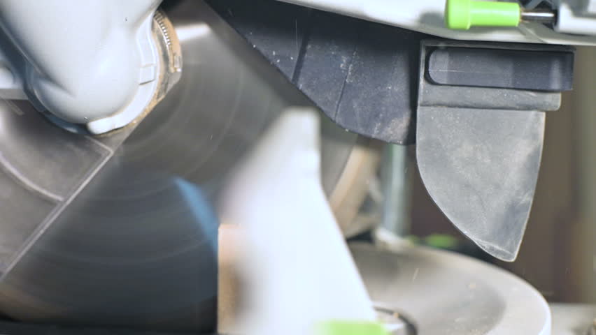 Close-up of a work on a machine with a circular saw. Cutting wooden billet circular machine in slow motion