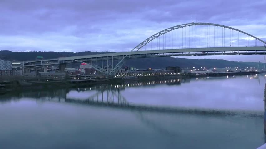 Evening twilight view of Portland, Oregon downtown from Willamette river bank