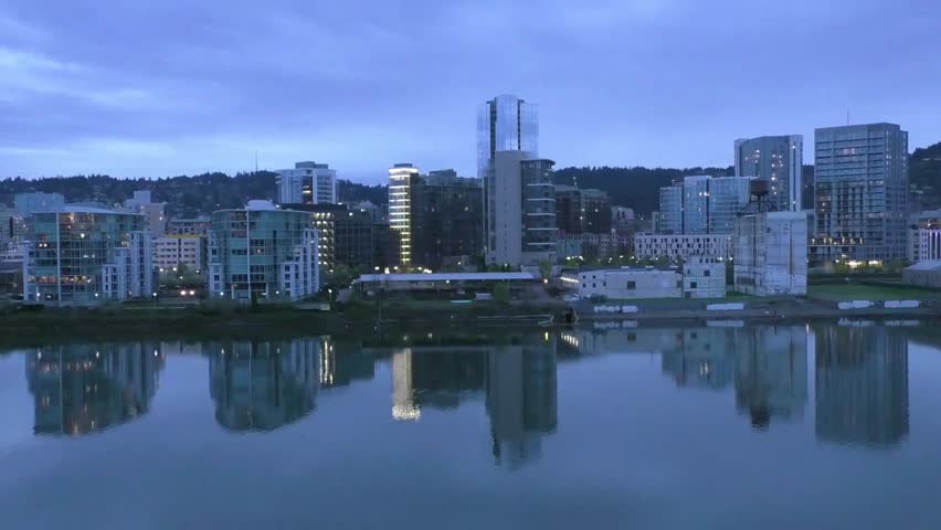 Evening twilight view of Portland, Oregon downtown from Willamette river bank