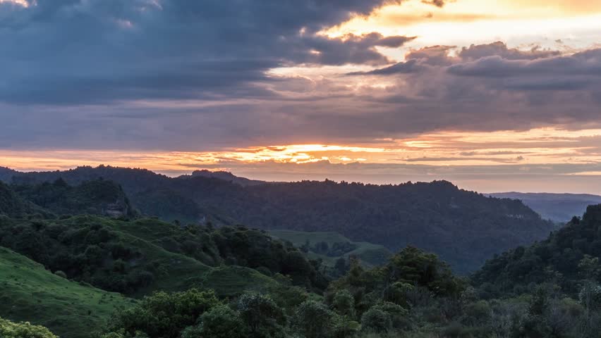 Beautiful sunrise over wild forest mountains in summer morning in New Zealand nature Time lapse | Shutterstock HD Video #1027288325