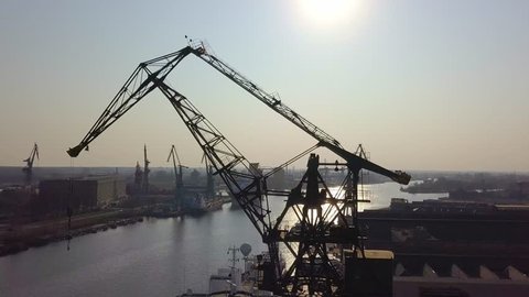 Aerial of Port Crane Over Shipyard Docks