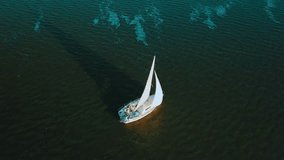 Aerial shooting seascape view yachting of waves under blue Sea in summer sunny day, Drone 4K Video.
