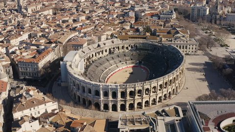 Aerial view flying around the Arena of Nîmes a roman amphitheatre during winter sunny day 