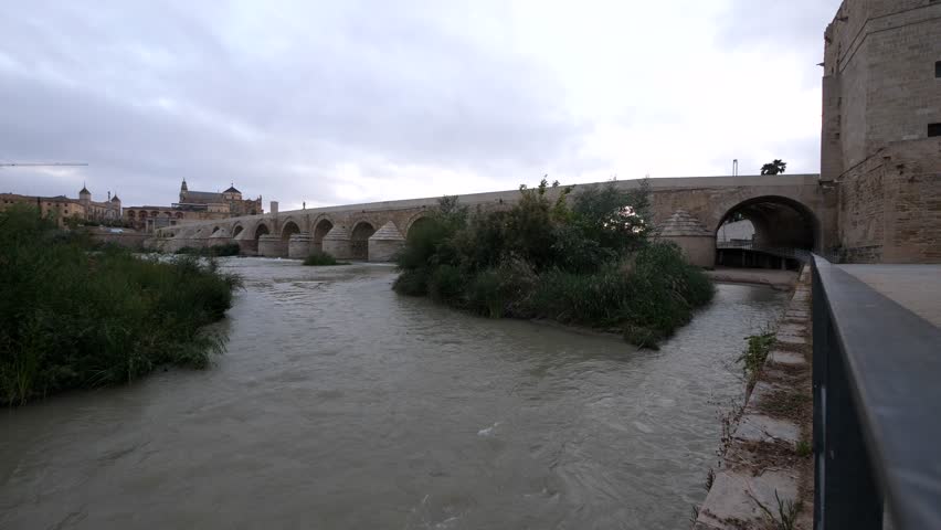 Roman Bridge at sunshine with Mezquita Cathedral in the background. Cordoba. Andalusia, Spain.