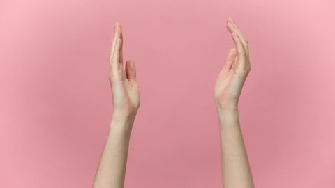 Woman hands clapping applause and showing two thumbs up gesture isolated over pastel pink background in studio. Copy space for advertisement. With place for text or image. Advertising area, mock up.
