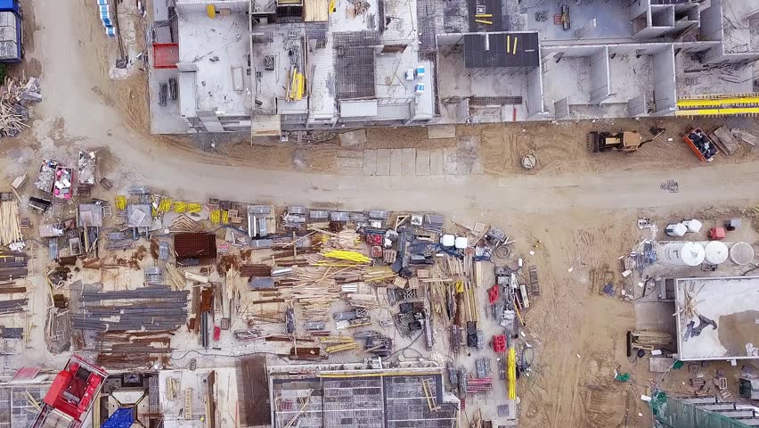 Construction of a residential building. Cranes and constuction site. Drone footage. Lookdown flyby shot. Gdansk, Poland.
