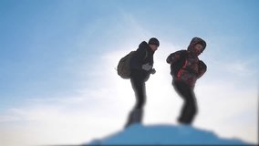 teamwork business concept slow motion video. group team tourist hikers walking gives climb to the top of the mountain. success win winter reached the top of the mountain. tourists climbers climb to