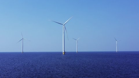 WindTurbines in a very blue sea on a beautiful sunny day.