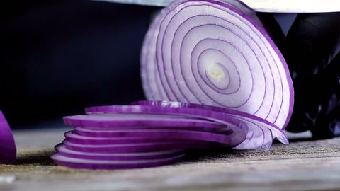 Italian red Tropea onions cutted slice before frying in extra virgin olive oil in slow motion , concept of Italian and Mediterranean diet , diet concept and healthy life