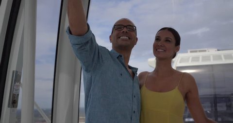 Couple Takes Selfie at Top of Orlando Ferris Wheel, Skyline View