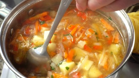 Vegetable soup cooks in a pan.