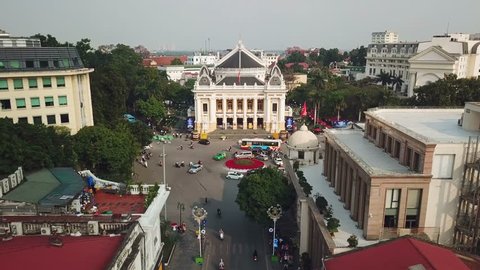 Unique descent close to facade opera house central Hanoi Vietnam French colonial. Circular interchange road traffic Transport bikes. City life Important sights. Culture history. Aerial