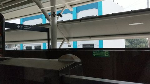 Jakarta, Indonesia - April 7, 2019: Window view of a moving MRT Jakarta train on elevated railway tracks.