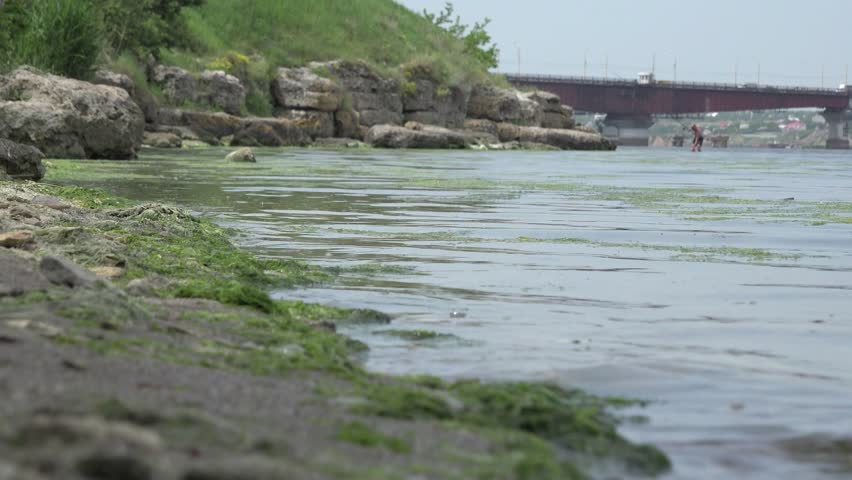 Old pier with boat in background Bridge over river