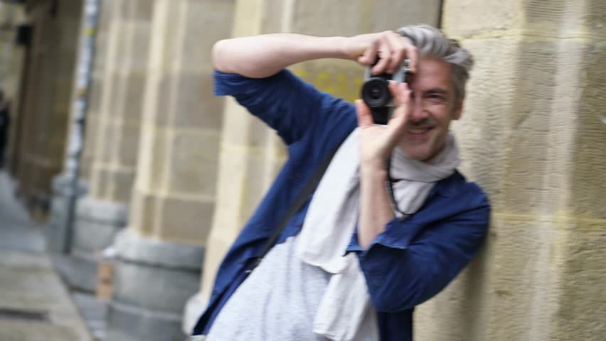 Amateur photographer taking photos in European town