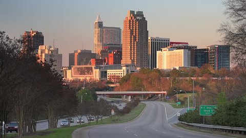 RALEIGH, NORTH CAROLINA - MARCH 30, 2015: Traffic flows into the Raleigh downtown skyline. Raleigh is the state capital of North Carolina.