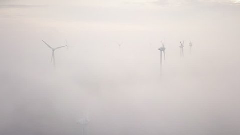 Wind turbines Energy Production. Background for the theme: dream, lightness, fog. Renewable energy concept.