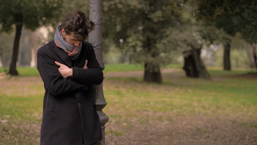 appointment, late.Attractive man alone in the park waiting for girlfriend