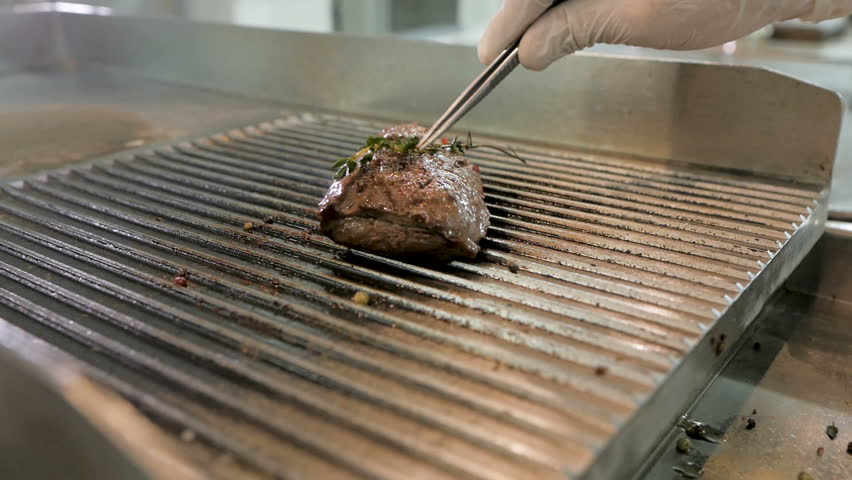 Large piece of beef meat prepared on a grill pan