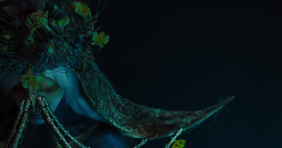 Portrait of Caucasian male with complex warrior floral make-up posing in creative lighting. Body painting fashion project. Model and property released. 4K UHD RAW FOOTAGE