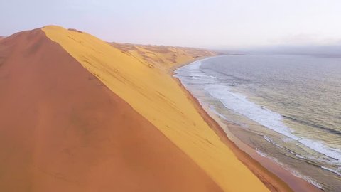 SKELETON COAST, NAMIBIA - CIRCA 2018 - Astonishing aerial shot over the vast sand dunes of the Namib Desert along the Skeleton Coast of Namibia.