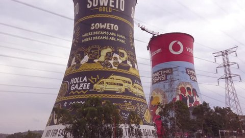 SOWETO, SOUTH AFRICA - CIRCA 2018 - POV from a passing car of painted cooling towers in Soweto, South Africa.