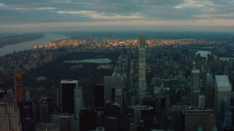 Aerial view of buildings and skyscrapers leading towards Central Park and the Hudson River, New York City, at sunset during winter. Shot on 4k RED camera.