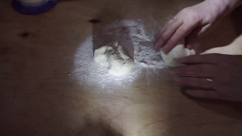 Rolling out dough with pin on a cutting board