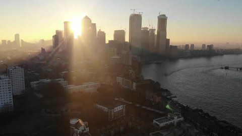 Aerial view of Canary Wharf, London's financial district at sunrise as the sun was passing behind the tall buildings
