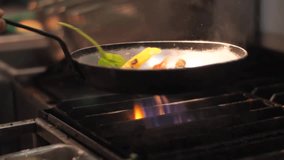 Cooking vegetables on fire at restaurant. Cooking Vegetables. Frying Pan. Preparing Vegetarian Food. Slow Motion Video Footage