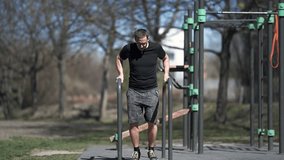 Amateur athlete workout in outdoor street gym.
Triceps strengthening exercise stock video 4K.