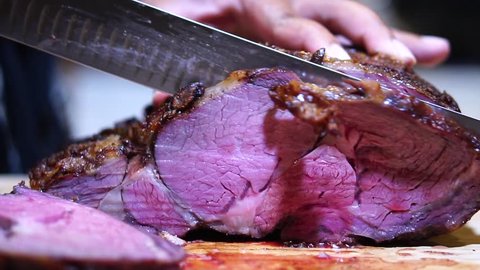 SLOW MOTION carving beef roast with Granton edge carving knife, Close Up