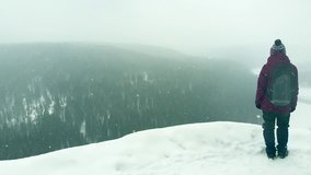 Hiking teen girl enjoying beautiful cliff view in winter, aerial view. Hiking trails in national park.  Inspiration video, explore nature, trekking adventure, tourism concept. Wanderlust and travel