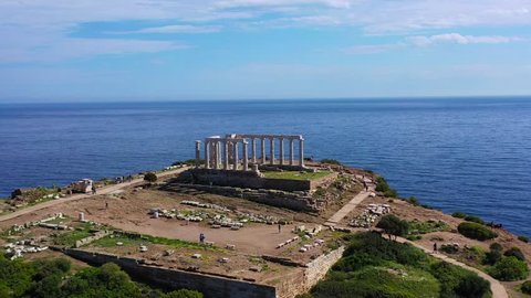 Aerial drone bird's eye view video of famous archaeological site of Cape Sounio and Ancient temple of Poseidon, Attica, Greece