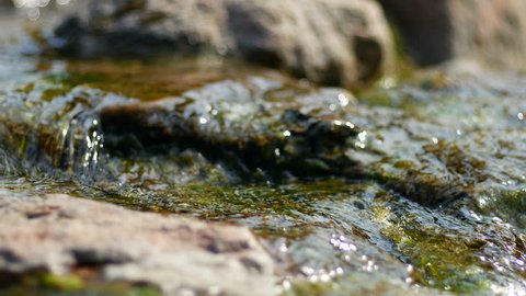 Stones in stream with smooth flowing water. Stones in stream with smooth flowing water.