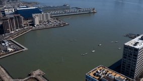 Time Lapse City Harbor With Boats Floating While Ships Sail Past And Ferry Arrives Across From New York City, Drone Aerial Footage 