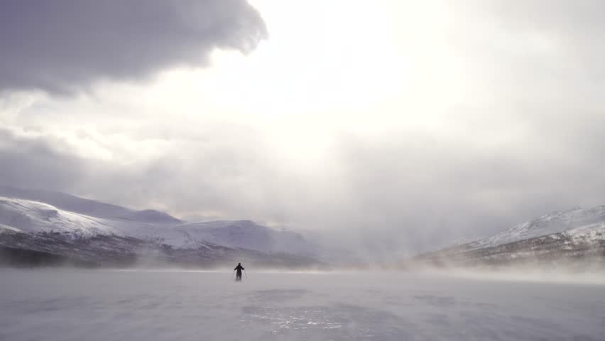 High winds while cross-country skiing over a frozen river in Sarek. Lapland, Sweden. Royalty-Free Stock Footage #1027424273