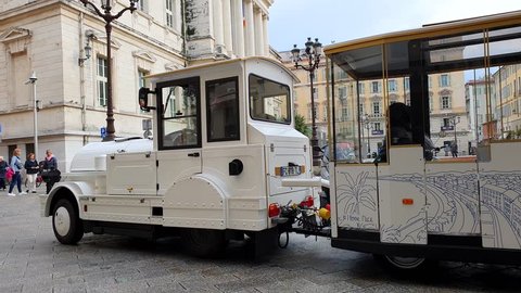 Nice, France - April 11, 2019:  White Tourist Train Tour For Sightseeing, Place Du Palais De Justice In The City Center Of Nice On The French Riviera, France, Europe - 4K Video