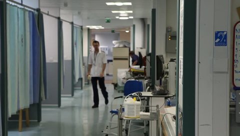 LONDON, UK - 2019: NHS A and E busy ward doctor and porter