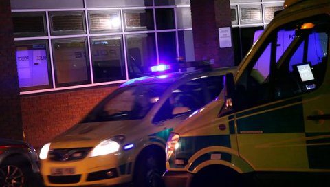 LONDON, UK - 2019: NHS Accident and Emergency exterior as police car flashes lights and leaves