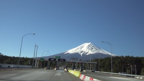 On-vehicle camera image passing through the gate and running along Fuji Five Lakes trail, looking at Mt. Fuji in front,